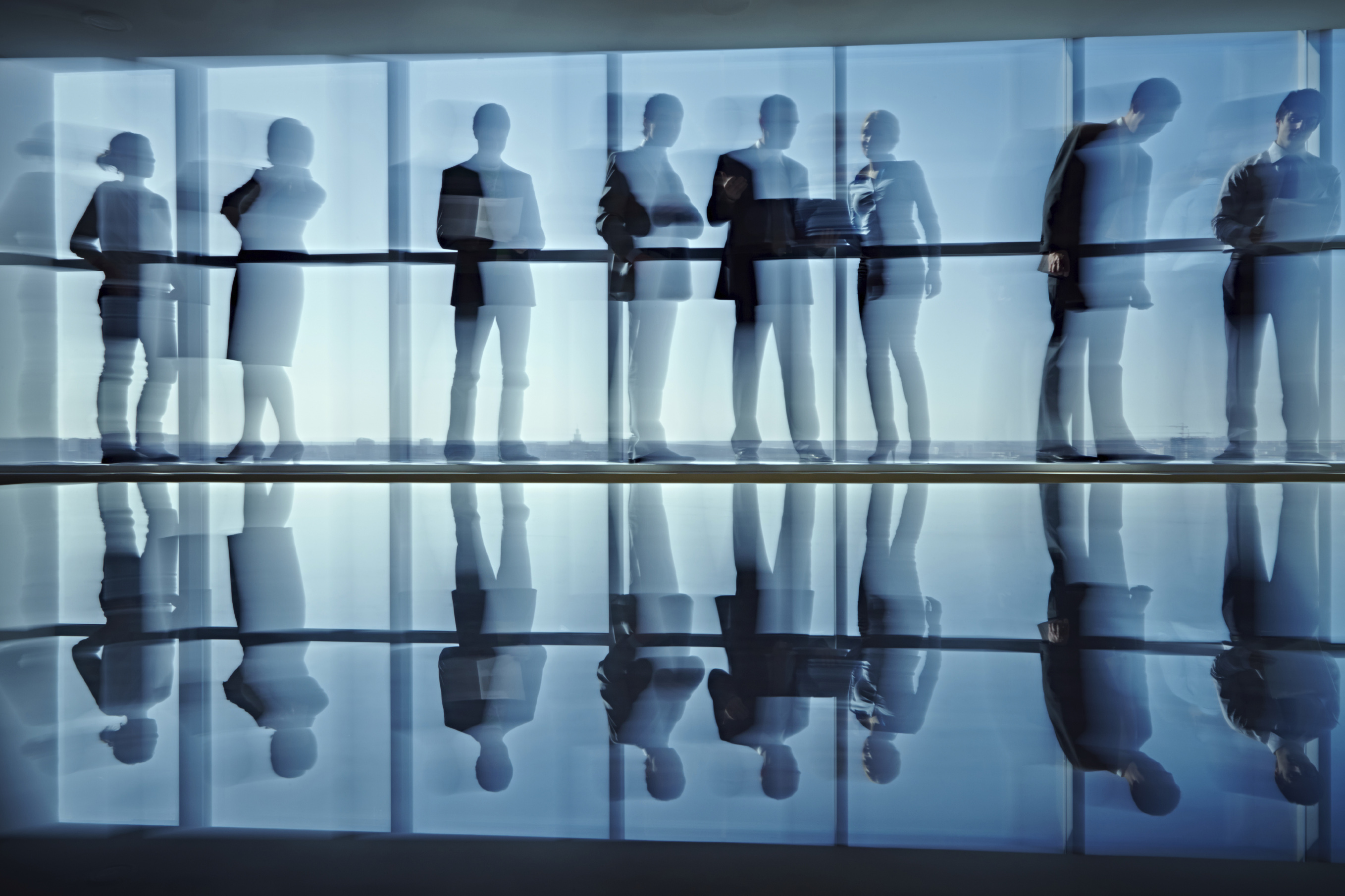 Blurred motion of business people standing at office